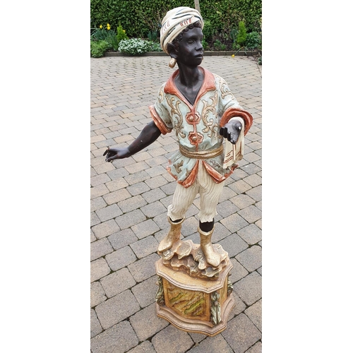 355 - A large Italian Blackamoor Figure of a young Boy on a stand. 152 cms high approx.