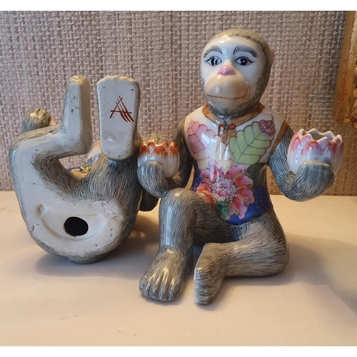 87 - An unusual pair of Oriental Monkeys with painted decoration. 21 cms approx.