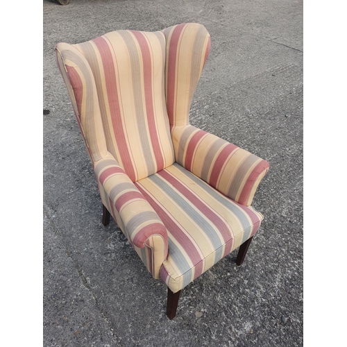 656 - A good and well upholstered Wing Back Chair.