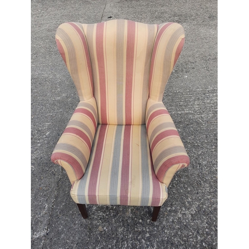 656 - A good and well upholstered Wing Back Chair.