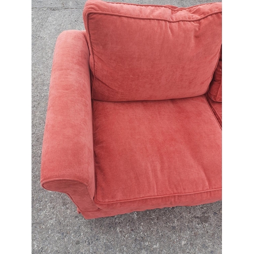 671 - A very clean Pink/Salmon two seater Couch. 175w x 87 deep cms. 