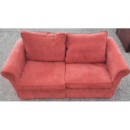671 - A very clean Pink/Salmon two seater Couch. 175w x 87 deep cms. 