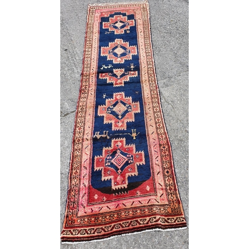 214 - A large Iranian Runner with blue ground and a unique cross design with animal motifs.350 x 103 cms a... 