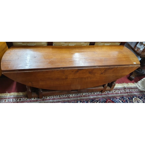 96 - A lovely reproduction Walnut Gate Leg Oval Dining Table.200 X 151 X H 74 cms.