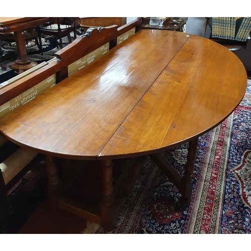 96 - A lovely reproduction Walnut Gate Leg Oval Dining Table.200 X 151 X H 74 cms.