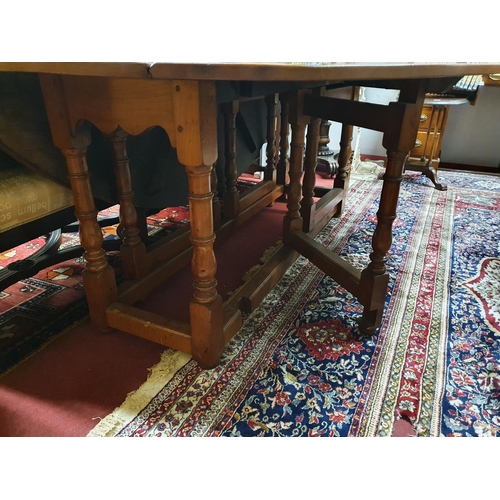 96 - A lovely reproduction Walnut Gate Leg Oval Dining Table.200 X 151 X H 74 cms.