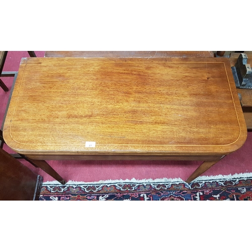 314 - A Regency Mahogany Foldover Tea Table with boxwood inlay on tapered supports. Size W 91 X 91 X H 73c... 