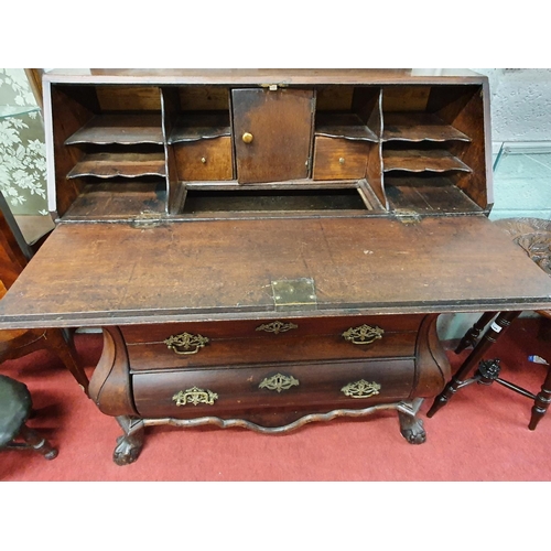 145 - A 19th Century Oak Continental Bureau with a bombe shape outline. w 104 x d 48 x H 113 cms approx.