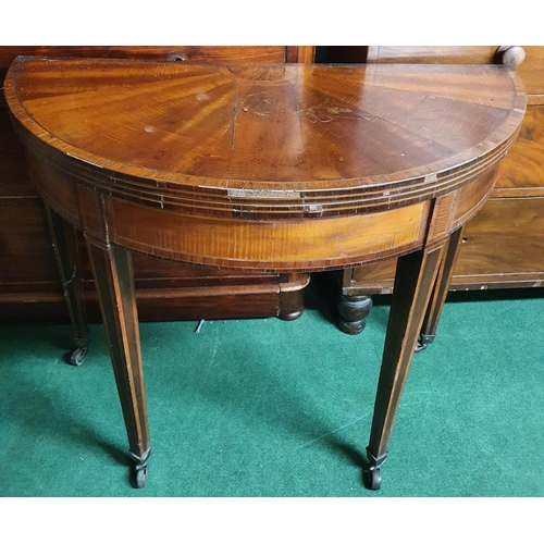 78 - A 19th Century Mahogany and Veneered half moon fold over Card Table, the top is veneered in a sunbur... 