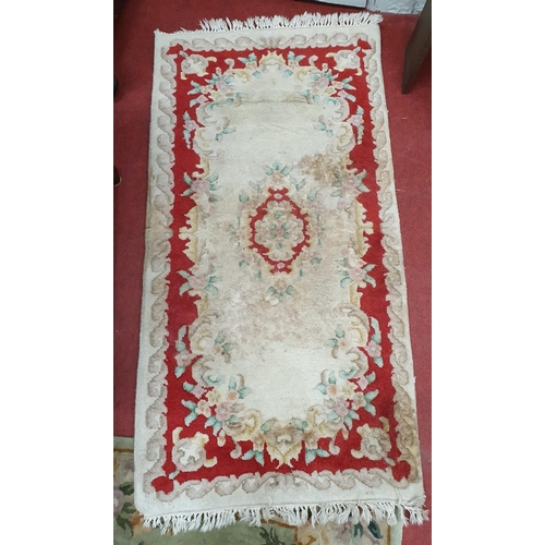 229 - Three Oriental Rugs. 62 x 130 cms and 154 x 78 cms approx (x2).