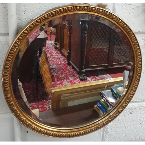 252 - A 19th Century Crutch Mirror with egg and dart moulded surround and beveled edge. D 39 cms approx.