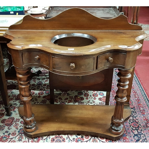 121 - A good 19th Century Serpentine fronted Washstand with turned and fluted supports on a platform base.... 