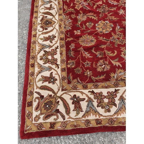 479 - A large deep pile red/burgundy ground Oriental Carpet with multi borders and all over decoration. 30... 