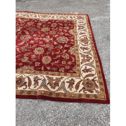 479 - A large deep pile red/burgundy ground Oriental Carpet with multi borders and all over decoration. 30... 