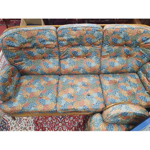 236 - An Ercol  three seat sofa and two matching chairs with upholstered seat and back cushions.