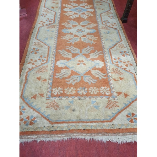 255a - A rust ground Runner. 302 x 82 cms approx.