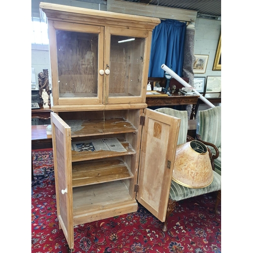 561 - A 19th Century stripped pine Food Cupboard with brass grill lower doors and glazed upper. W 82 x D 5... 