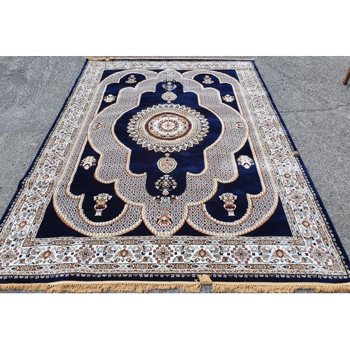 1051 - A Persian Super Izmir carpet with ink blue ground, central medallion with white/Ivory field and flor... 