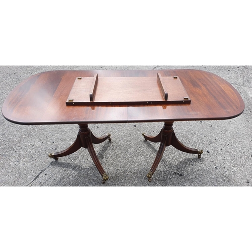 1053 - A Regency Mahogany two pillar Table on tripod bases.