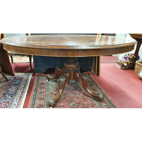 235 - A fantastic Victorian Walnut Inlaid oval Supper Table with splayed carved pod.c1860. 145 x 117 cms a... 