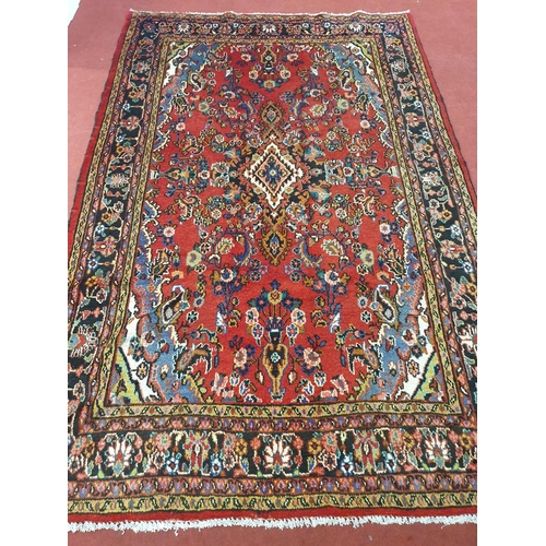 1008 - A Persian Soruk red ground full pile Rug with a traditional medallion design, multi borders and all ... 