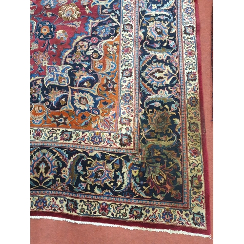 1039 - A large Vintage multi coloured Iranian Carpet from the Marshad region with a floral medallion design... 