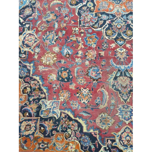 1039 - A large Vintage multi coloured Iranian Carpet from the Marshad region with a floral medallion design... 