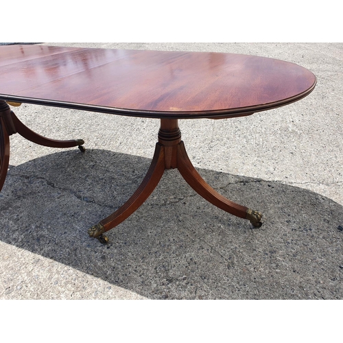 1076 - A Regency Mahogany two pillar Table on tripod bases.