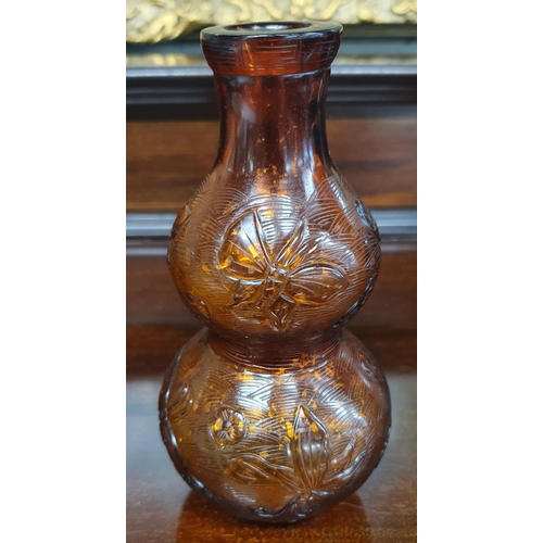 509 - An 18th Century Beijing Glass with gold flaking in glass, foundry marble to the base. H 15.5 cms app... 