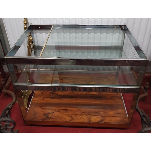 597 - Of superb quality. A Danish designed Chrome Rosewood and glass three tier Side Table. 74 x 47 x 65H ... 