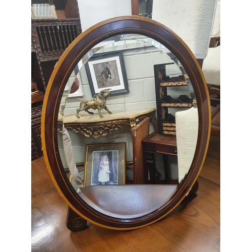 719 - A good early 20th Century grained oval bevelled edge Mirror. 67 x 54H cms approx.