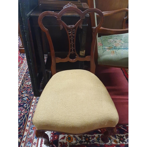 826 - A nice Edwardian Mahogany bedroom Chair with a highly carved back. W 50 x seat H 47 cms approx.