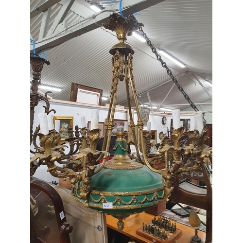 831 - A large gilded Bronze Rococo Chandelier with green body and stairs.