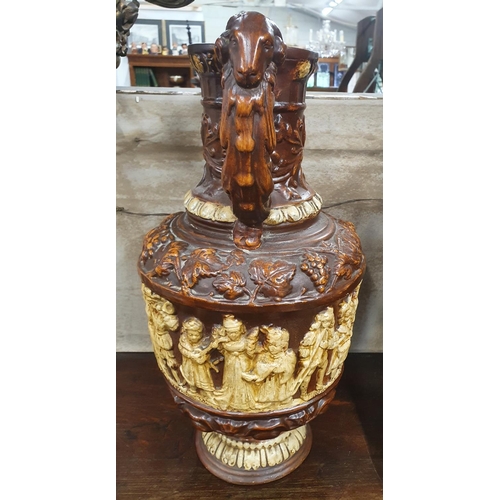 835 - A very large terracotta Vase with relief moulded exterior. H 42 cms approx.