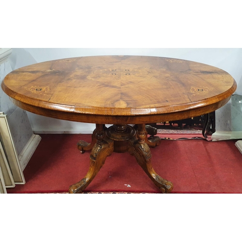 856 - A Victorian Walnut Inlaid Oval Supper Table on quadrant base. 87 x 115 x H 73 cms approx.