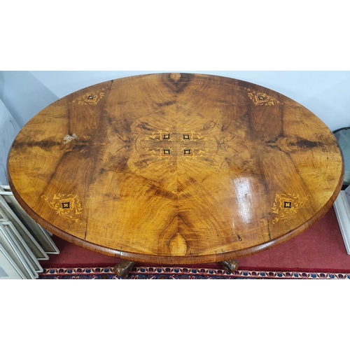 856 - A Victorian Walnut Inlaid Oval Supper Table on quadrant base. 87 x 115 x H 73 cms approx.