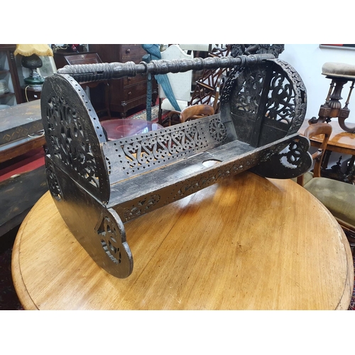 866 - An unusual Oriental Rocking Cradle. 97 x 60 x H 60 cms approx.