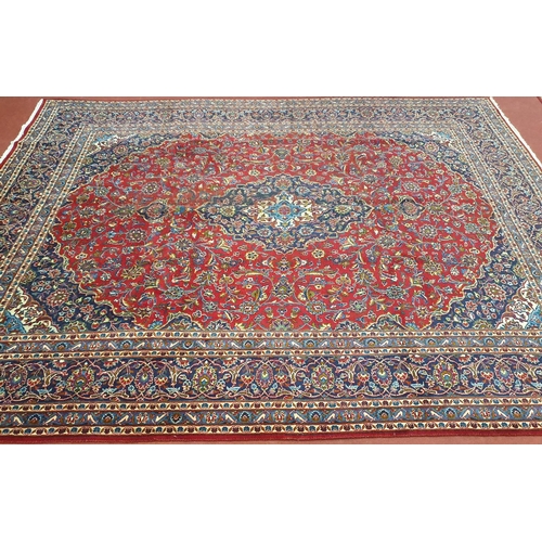 874 - A fantastic Large and hand woven red ground Iranian Carpet from the Kashan region with an medallion ... 