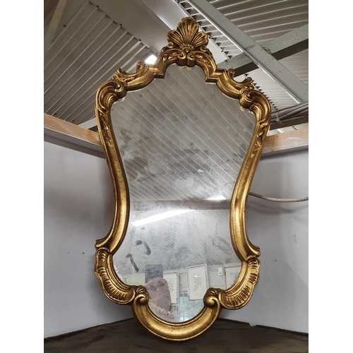 887 - A highly moulded Gilt Mirror. H 80 cms approx.