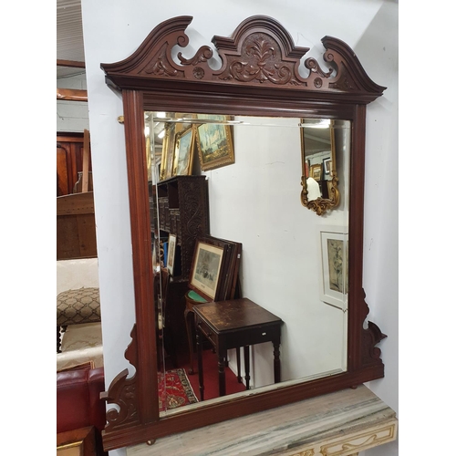 907 - A 19th Century Walnut Overmantel Mirror with bevelled glass. 96 x 150 cms approx.