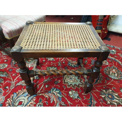 915 - An early 20th Century Cane topped Stool. 52 x 38 x H 48 cms approx.