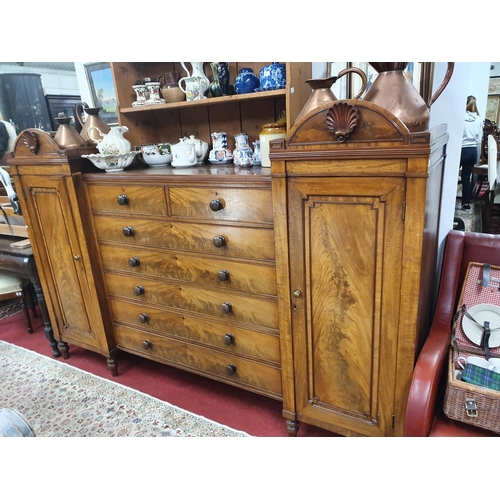 925 - A fantastic William IV Irish Linen Press with a bank of drawers flanking twin presses of a low heigh... 