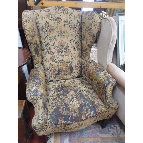 963 - An early 19th Century Mahogany and upholstered Wingback Chair with tapered front supports.