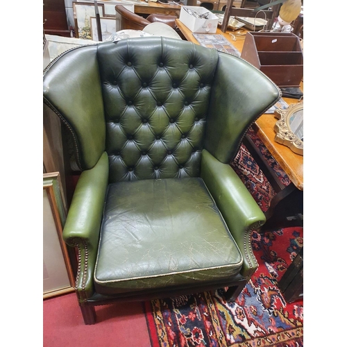 1027 - A pair of green Leather Wing Back Chairs with deep buttoned back. Cushion on one needs work.W 72 x s... 