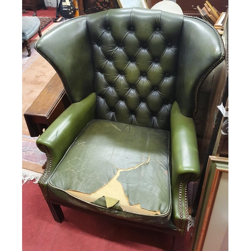 1027 - A pair of green Leather Wing Back Chairs with deep buttoned back. Cushion on one needs work.W 72 x s... 