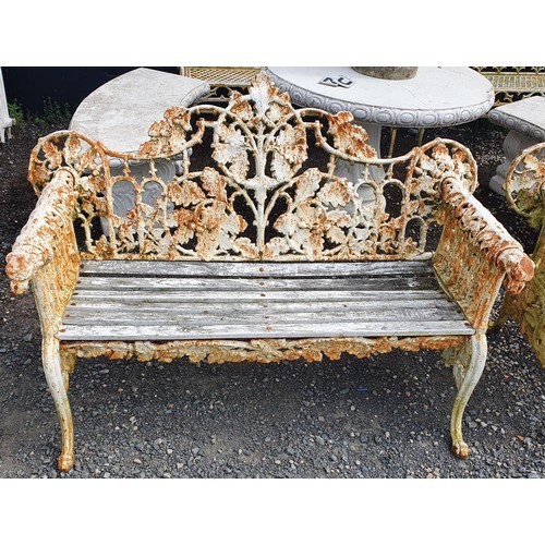 419 - A really good heavy cast Iron Garden Bench with oak leaf scroll design and dogs head arms.