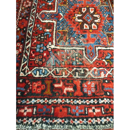 120 - A large red ground Persian Henries Runner with bespoke medallion design. 380 x 91 cms approx.