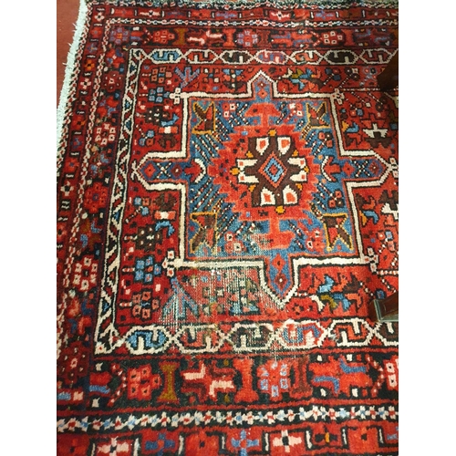 120 - A large red ground Persian Henries Runner with bespoke medallion design. 380 x 91 cms approx.