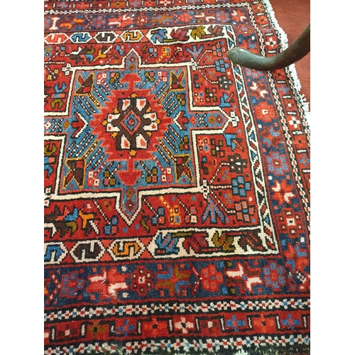 120 - A large red ground Persian Henries Runner with bespoke medallion design. 380 x 91 cms approx.