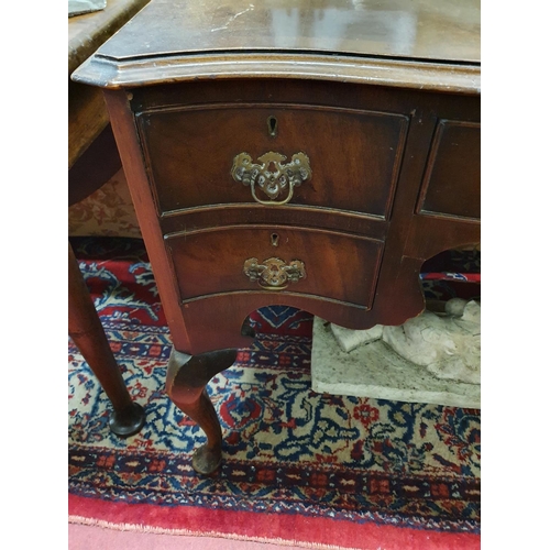 556 - A late 19th early 20th Century Serpentine fronted Mahogany Desk with cabriole supports. 106 x 50 x 7... 